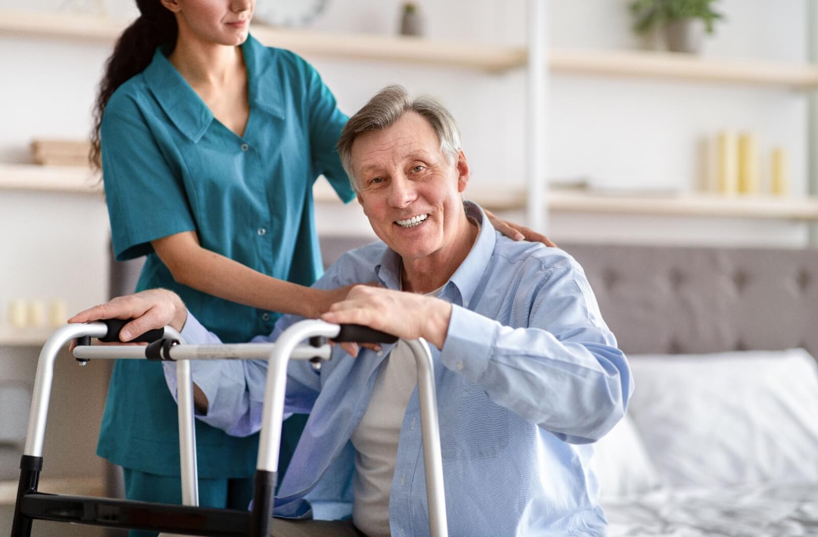 A senior man receiving specialized medical assistance from a caregiver as part of his post-acute brain injury rehabilitation program.