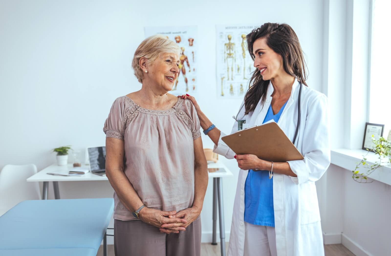 A doctor speaking with her older adult patient about the importance of health screenings.