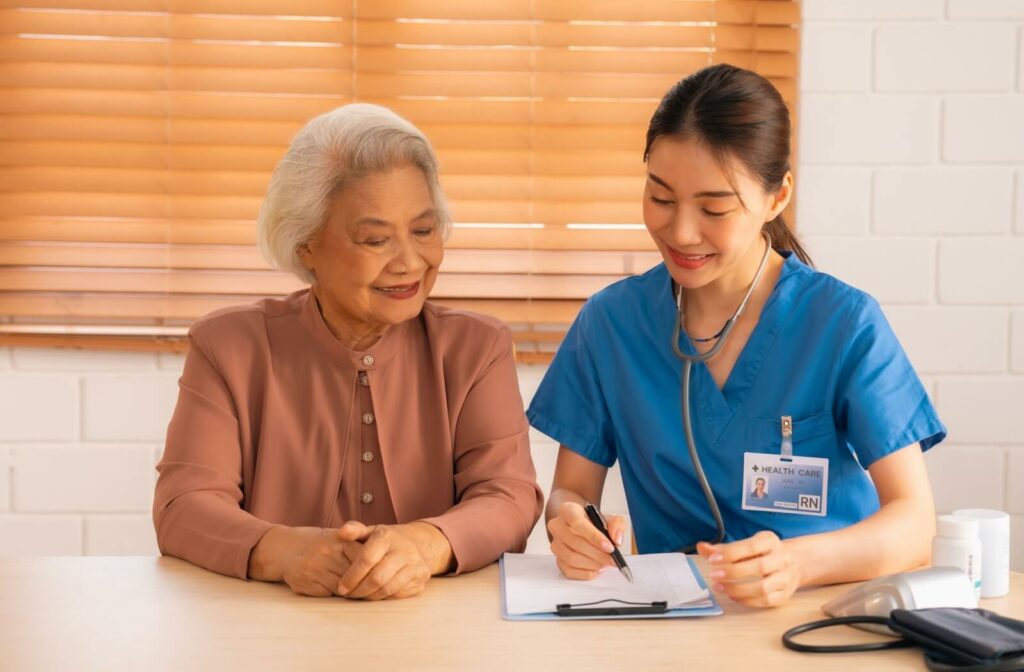 A nurse walks provides personalized support to an older adult, walking them through a list of holistic care options.