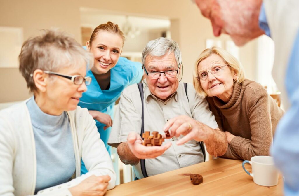 A group of older adults work on a puzzle with the help of a nurse in a long-term skilled care community.