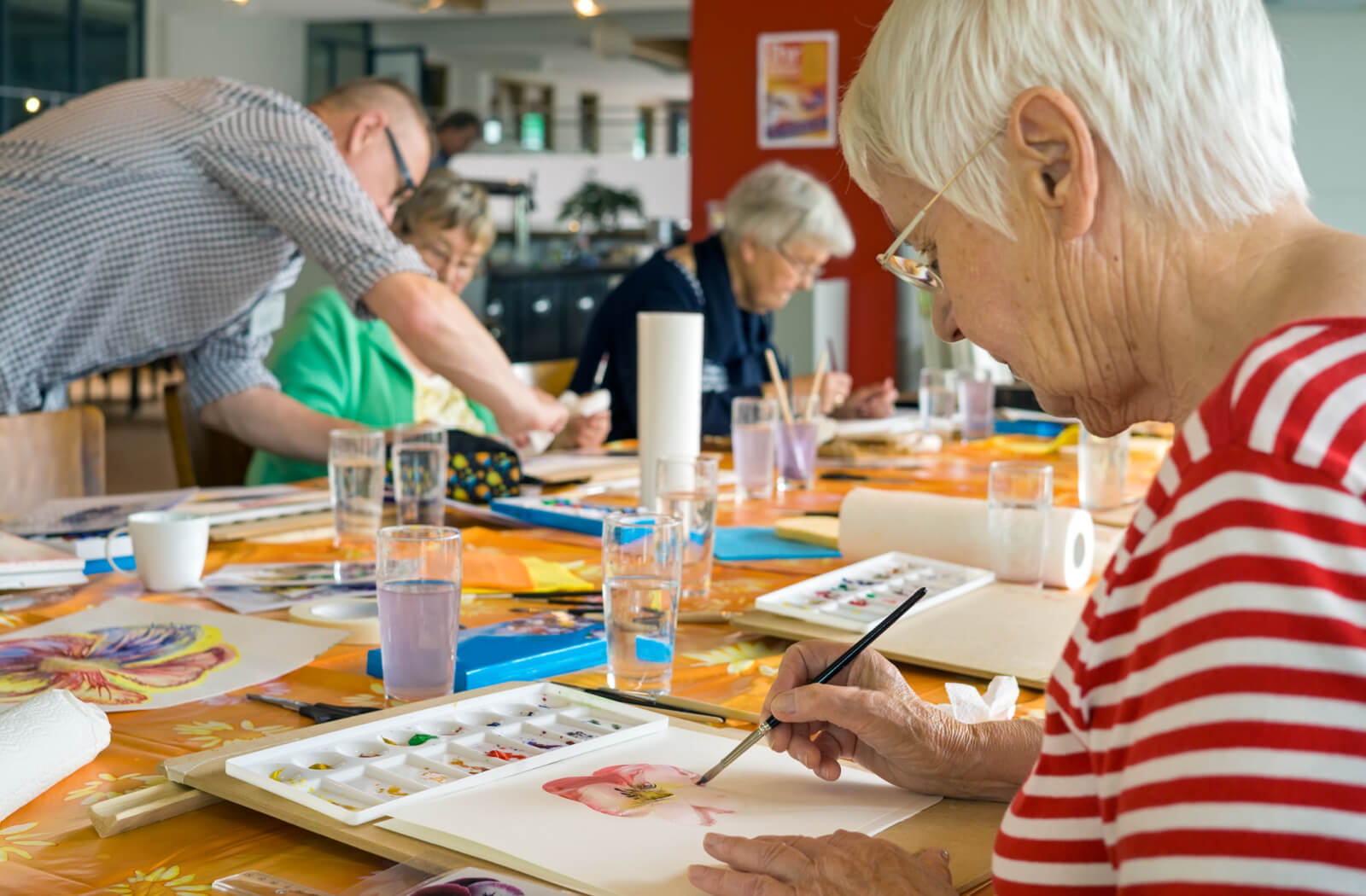 A group of seniors painting in their art class.